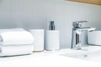 a bathroom sink with towels and a faucet at Beachside 2 bedrooms apartment 200 meters to Bang Tao Beach Manage by OCEAN HUB in Bang Tao Beach