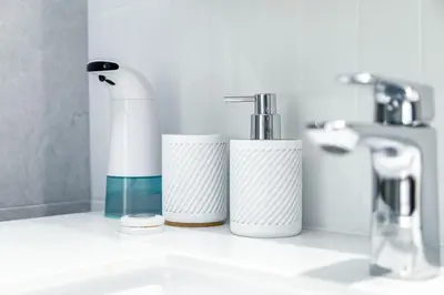 three cups sitting on a counter next to a sink at Beachside 2 bedrooms apartment 200 meters to Bang Tao Beach Manage by OCEAN HUB in Bang Tao Beach