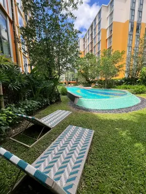 a swimming pool with a hammock in a yard at The Base Rise Central Phuket in Ban Rangeng