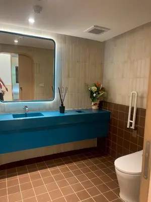 a bathroom with a blue sink and a toilet at The Base Rise Central Phuket in Ban Rangeng