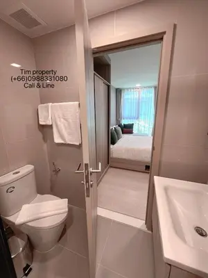 a bathroom with a toilet and a sink and a bed at The Base Rise Central Phuket in Ban Rangeng