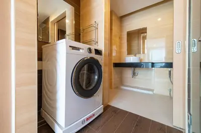 a washer and dryer in a small bathroom at Hillside 2BR Apartment with Pool & Gym 5 Min to Kamala Beach 48RK in Kamala Beach