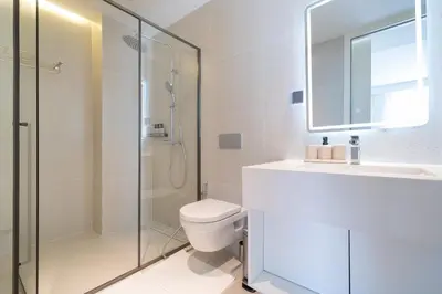 a bathroom with a shower and a toilet and a sink at Sunshine Beach Luxury 3-bedrooms with a great view in Layan Beach