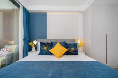 a bedroom with a bed with blue and yellow pillows at Sunshine Beach Luxury 3-bedrooms with a great view in Layan Beach