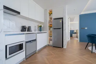a kitchen with white cabinets and a refrigerator at Sunshine Beach Luxury 3-bedrooms with a great view in Layan Beach