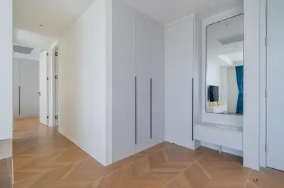 an empty hallway with white walls and wooden floors at Sunshine Beach Luxury 3-bedrooms with a great view in Layan Beach