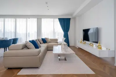 a living room with a couch and a tv at Sunshine Beach Luxury 3-bedrooms with a great view in Layan Beach