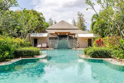 a swimming pool in front of a house at Tree Resort Palai v2 in Chalong