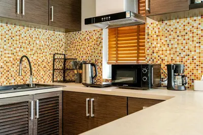 a kitchen with a sink and a microwave at Tree Resort Palai v2 in Chalong