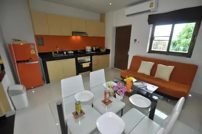 a kitchen and living room with a table and chairs at Duangjai Residence, Rooms & Apartments in Rawai Beach
