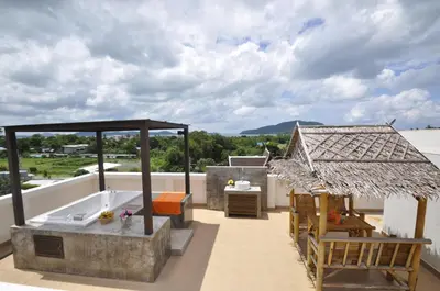 a rooftop patio with a tub and a grill at Duangjai Residence, Rooms & Apartments in Rawai Beach