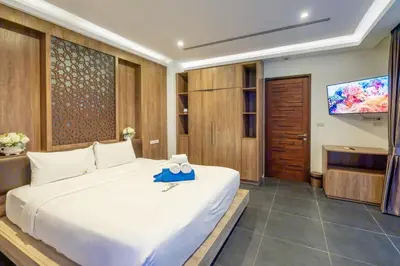 a bedroom with a large white bed and a television at New Primrose Pool Villa Your Own Secluded Paradise in Rawai Beach