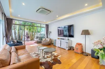 a living room with a couch and a tv at New Primrose Pool Villa Your Own Secluded Paradise in Rawai Beach
