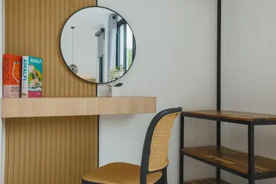 a mirror on a wall with a chair and a table at Wink Hill 1 Penthouse Patong 4 Bedrooms in Patong Beach