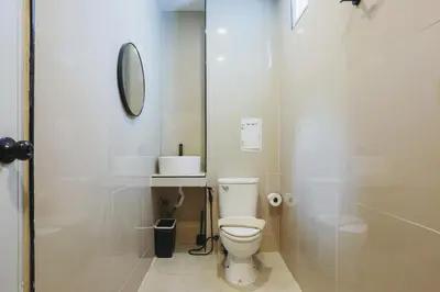 a white bathroom with a toilet and a shower at Wink Hill 1 Penthouse Patong 4 Bedrooms in Patong Beach