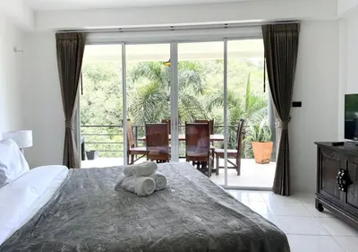 a bedroom with a bed with a stuffed animal on it at Quiet Seaview House 1 Bedroom Patong in Patong Beach