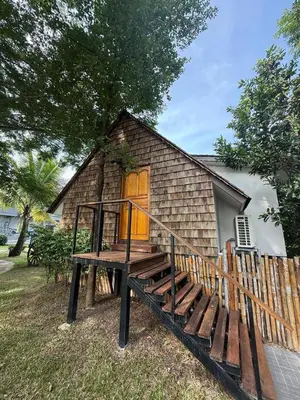a small house with a wooden staircase in front of it at The wide view resort and restaurant Phuket in Thalang