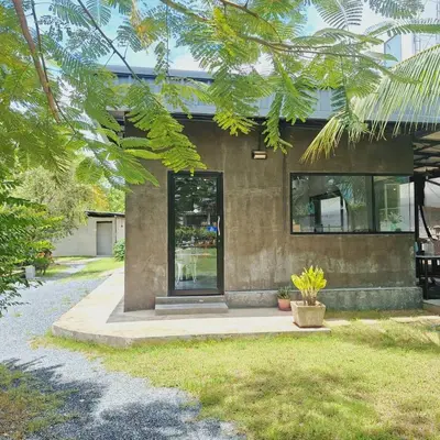 a house with a glass door in a yard at The wide view resort and restaurant Phuket in Thalang