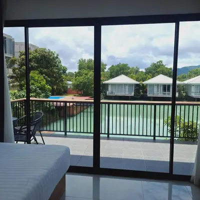 a room with a view of a balcony with a bed at The wide view resort and restaurant Phuket in Thalang