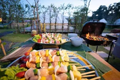two plates of food on a table next to a grill at The wide view resort and restaurant Phuket in Thalang