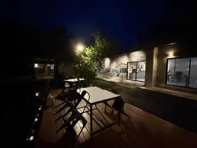two tables and chairs on a deck at night at The wide view resort and restaurant Phuket in Thalang