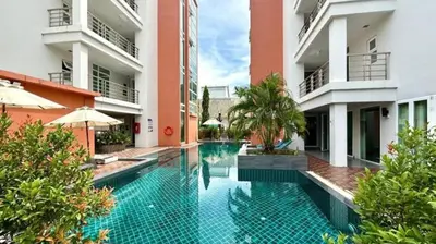 a swimming pool in the middle of a building at Palace - Spacious 1 bedroom Condo with shared Pool in Patong Beach