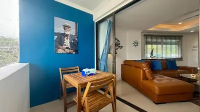 a living room with a couch and a table at Palace - Spacious 1 bedroom Condo with shared Pool in Patong Beach