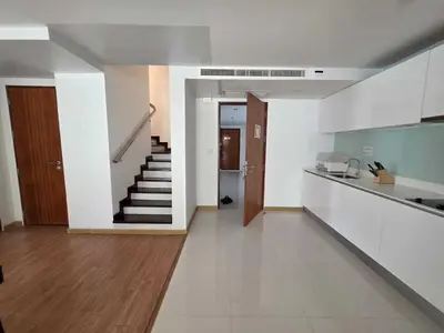 a living room with a staircase and a kitchen at Penthouse 3 bedrooms with sea view and pool - Privilege residence in Patong Beach