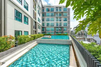 a swimming pool in the middle of a building at C237 Brand New 1BR Condo Pool Gym Near Beach in Bang Tao Beach