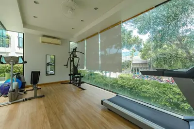a room with a gym with a large window at C237 Brand New 1BR Condo Pool Gym Near Beach in Bang Tao Beach