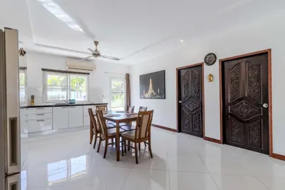 a kitchen and dining room with a table and chairs at V245 3BR with Pool Close to Phuket Best Beaches in Rawai Beach