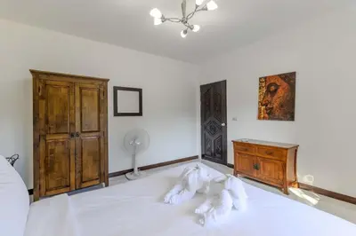 a bedroom with a bed with white sheets and a dresser at V245 3BR with Pool Close to Phuket Best Beaches in Rawai Beach
