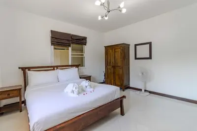 a bedroom with a bed with two stuffed animals on it at V245 3BR with Pool Close to Phuket Best Beaches in Rawai Beach