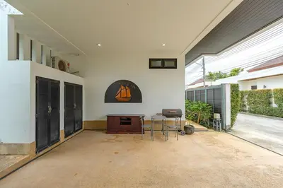 a living room with a table and chairs in a house at V246 Spacious 4BR Near Pier Private Pool & Garden in Rawai Beach