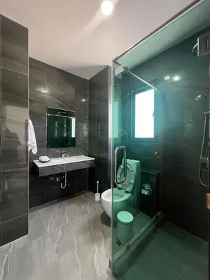 a bathroom with a shower and a toilet and a sink at HEART of RAWAI, 4BR Private pool in Rawai Beach