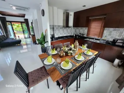 a dining room table and chairs in a kitchen at HEART of RAWAI, 4BR Private pool in Rawai Beach