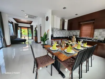 a kitchen and dining room with a wooden table and chairs at HEART of RAWAI, 4BR Private pool in Rawai Beach