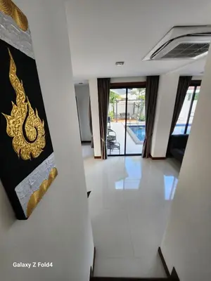 a hallway in a house with a painting on the wall at HEART of RAWAI, 4BR Private pool in Rawai Beach