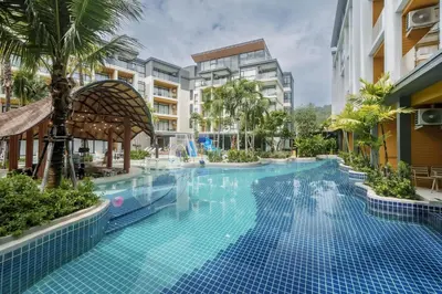 a large swimming pool in a building with a resort at Pool View Condo 2204 Wyndham Garden Resort in Phuket Town