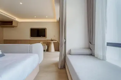 a hotel room with a bed and a tv at Pool View Condo 2204 Wyndham Garden Resort in Phuket Town