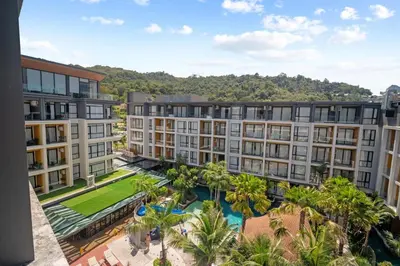 an aerial view of a building with palm trees at Pool View Condo 2204 Wyndham Garden Resort in Phuket Town