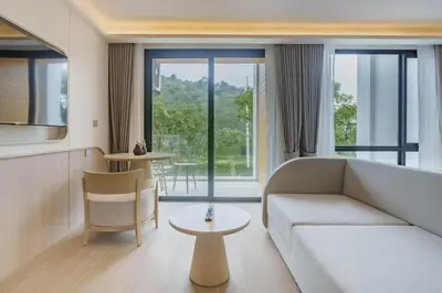 a living room with a couch and a table at Wyndham Gardens Elegant Studio Forrest View 2228 in Phuket Town