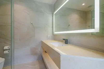 a bathroom with a sink and a mirror at Wyndham Gardens Elegant Studio Forrest View 2228 in Phuket Town