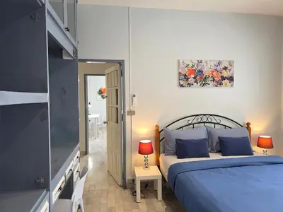 a bedroom with a bed with blue pillows at Moonlight Naka in Ban Rangeng