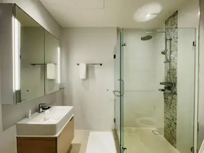 a bathroom with a sink and a glass shower at Daimond resort condominium by koy in Patong Beach