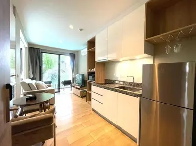 a kitchen with a stainless steel refrigerator and a table at Daimond resort condominium by koy in Patong Beach