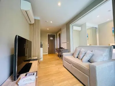 a living room with a couch and a flat screen tv at Daimond resort condominium by koy in Patong Beach