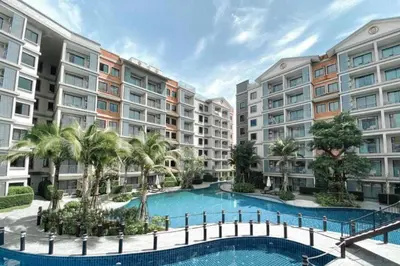 an apartment complex with a swimming pool and palm trees at Pool Side Retreat 1 BED - TC-B105 in Phuket Town