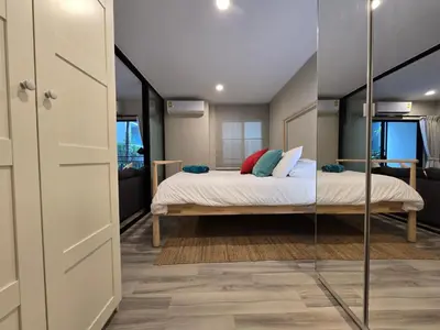 a bedroom with a bed and a mirror at Pool Side Retreat 1 BED - TC-B105 in Phuket Town