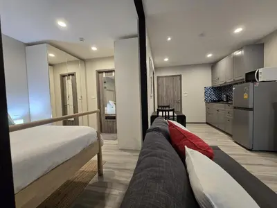 a large bedroom with a bed and a kitchen at Pool Side Retreat 1 BED - TC-B105 in Phuket Town